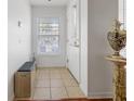 Bright entryway featuring tile floors, a bench, and natural light at 3866 Mariner Dr, St Petersburg, FL 33705