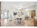 Bright dining area with tile flooring, white table and chairs, mirrored wall, and built-in display cabinet at 4229 Glissade Dr, New Port Richey, FL 34652