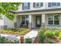 Charming front porch with rocking chairs and beautifully landscaped walkway creates a welcoming entrance at 4496 Tatum Loop, Odessa, FL 33556