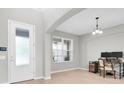 Bright living room featuring wood floors, a large window and a stylish desk area at 4496 Tatum Loop, Odessa, FL 33556