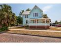 Beautiful light blue two-story home with a cozy wrap-around porch at 457 8Th N Ave, St Petersburg, FL 33701
