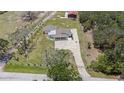 Expansive property featuring a home with a long patterned stone driveway and separate garage at 5012 Troydale Rd, Tampa, FL 33615