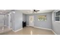 Bright living room with tile floors, a decorative front door, and ample natural light at 5012 Troydale Rd, Tampa, FL 33615