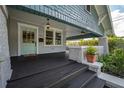 Inviting front porch with stylish lighting, classic columns, and a painted door, creating curb appeal at 5301 N Central Ave, Tampa, FL 33603