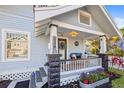 Charming front porch with stone columns, house number, and cozy seating area, surrounded by lush landscaping at 634 6Th N St, St Petersburg, FL 33701