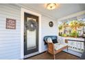 Cozy front porch featuring a wicker bench with decorative pillows and a charming welcome wreath on the door at 634 6Th N St, St Petersburg, FL 33701