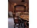 Comfortable home theater setup with large screen, projector, plush seating, and marble table at 6615 Vanda Ln, Land O Lakes, FL 34637