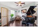 Cozy living area showcasing dark hardwood flooring, natural light, and a grand piano for entertainment at 6724 Clair Shore Dr, Apollo Beach, FL 33572