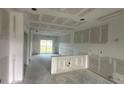 Unfinished living area showcasing drywall and sliding glass doors opening to the backyard at 6977 Hawksbury St, Englewood, FL 34224