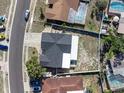 Overhead view of a house with a fenced backyard, showcasing the roof and surrounding landscape at 7131 Vista Way, Port Richey, FL 34668