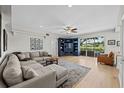 Spacious living room with hardwood floors, a large sectional, and a custom built in entertainment center at 9223 Brindlewood Dr, Odessa, FL 33556