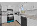 Bright kitchen with white cabinets, stainless steel appliances, and stylish countertops at 9810 N 53Rd St, Temple Terrace, FL 33617