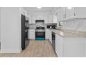 Updated kitchen featuring white cabinets, stainless steel appliances, and tile flooring at 9810 N 53Rd St, Temple Terrace, FL 33617