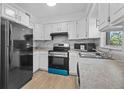 Well-lit kitchen with ample cabinet space, modern appliances, and tile backsplash at 9810 N 53Rd St, Temple Terrace, FL 33617