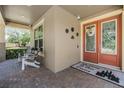 Cozy front porch with double doors, welcome mat and seating area at 10313 Scarlet Chase Dr, Riverview, FL 33569