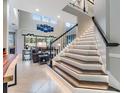 Elegant staircase with ambient lighting leading to the main living area at 10313 Scarlet Chase Dr, Riverview, FL 33569