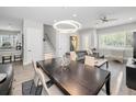 Open concept dining room and living room with modern decor and recessed lighting at 112 W Sligh Ave, Tampa, FL 33604