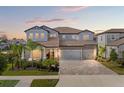 Beautiful two-story home with a three-car garage, complemented by lush landscaping and a spacious driveway at 13859 Sharp Hawk Dr, Riverview, FL 33569