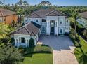 Expansive residence showcases a well-maintained lawn, intricate roofline, and stylish curb appeal from above at 14806 Harry Colt Ct, Tampa, FL 33626