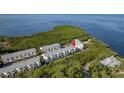 Aerial view of waterfront condos, lush greenery, and a serene coastal setting at 1500 Sunset Rd # C10, Tarpon Springs, FL 34689
