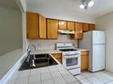 Functional kitchen features a full complement of appliances and tile countertops at 1510 Mission Hills Blvd # 19-F, Clearwater, FL 33759