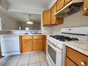 Well-lit kitchen includes a dishwasher and stove, perfect for cooking at 1510 Mission Hills Blvd # 19-F, Clearwater, FL 33759