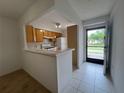 Efficient kitchen with classic cabinets and tile floor and breakfast bar at 1510 Mission Hills Blvd # 19-F, Clearwater, FL 33759