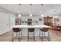 Modern kitchen features stainless appliances, a large island with seating, and dining area at 1528 Highland Park Dr, Clearwater, FL 33756