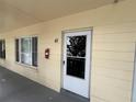 The entrance to unit 41 features impact windows and a screen door at 2295 Mexican Way # 41, Clearwater, FL 33763