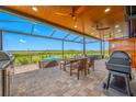 Stunning screened-in patio with an outdoor kitchen, dining area, and scenic views at 31775 Sun Kettle Loop Loop, Wesley Chapel, FL 33545