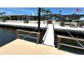 Inviting waterfront home featuring a private dock, fire pit, and ample outdoor seating, ideal for relaxation and entertainment at 3654 Corsair Ct, New Port Richey, FL 34652