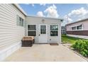 Outdoor patio with a grill and direct access to the outside featuring a welcoming door and ample natural light at 36750 Beth Ave, Zephyrhills, FL 33542