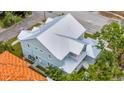 Aerial view of the home showcasing the metal roof, backyard, and surrounding neighborhood at 4311 W Sevilla St, Tampa, FL 33629