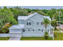 View of the house displaying the metal roof, garage, and side yard at 4311 W Sevilla St, Tampa, FL 33629