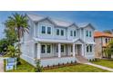 Charming two-story home featuring a metal roof, covered porch, and neatly landscaped front yard at 4311 W Sevilla St, Tampa, FL 33629