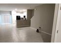 Open-concept living room boasts tile floors, flowing into the kitchen area with modern appliances at 4505 Globe Thistle Dr, Tampa, FL 33619