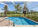 Enclosed pool area with stunning golf course views, beautiful blue water and stone waterfall feature at 4508 Netherwood Dr, Tampa, FL 33624