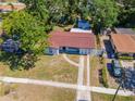 An aerial view showcases this charming single-story home with a spacious yard and driveway at 4706 E Sligh Ave, Tampa, FL 33610