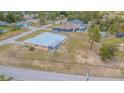 Spacious single-story home with a metal roof and screened in back porch, surrounded by a chain link fence at 5432 Queen Ave, Spring Hill, FL 34609