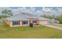 Lovely single-story home with a low maintenance yard, metal roof and attached two car garage at 5432 Queen Ave, Spring Hill, FL 34609