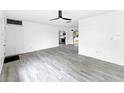 Spacious living room featuring modern flooring and a view into the kitchen at 8451 81St Way, Seminole, FL 33777