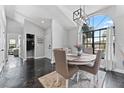 Bright dining room featuring a large window, modern lighting, and a stylish round table with comfortable seating at 8638 Chadwick Dr, Tampa, FL 33635