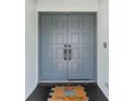 Elegant double front door with a decorative welcome mat adding a touch of warmth to the home's entry at 8638 Chadwick Dr, Tampa, FL 33635