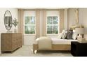 Cozy bedroom showcasing natural wood furniture, soft textures, and bright natural light at 9558 Runaway Breeze Dr, Land O Lakes, FL 34637