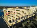 Exterior view of a multi-story condo building with balconies and water views at 100 Bluff View Dr # 514C, Belleair Bluffs, FL 33770