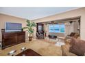 Living room with waterfront views, decorative curtains, and furnishings at 100 Bluff View Dr # 514C, Belleair Bluffs, FL 33770