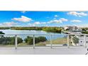 Beautiful water and nature views from the condo balcony with glass railing at 1020 Sunset Point Rd # 410, Clearwater, FL 33756