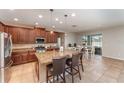 Open kitchen features granite countertops, stainless steel appliances, and a center island with bar seating at 11206 Coventry Grove Cir, Lithia, FL 33547