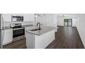 Open concept kitchen with granite countertops and stainless steel appliances at 11300 Libby Rd, Spring Hill, FL 34609