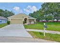 Inviting single-Gathering home features a manicured lawn and charming front yard landscaping at 11726 S Stone Ln, Riverview, FL 33569